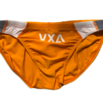 VXA men’s competitive swim brief in orange with white logo, front view